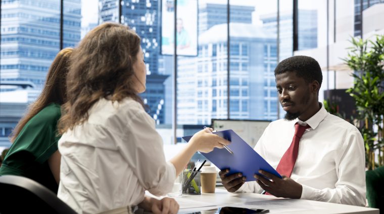 HT staff members checking if job candidate qualifications are aligned with company expectations. Human resources employees verifying resume before agreeing terms with job applicant