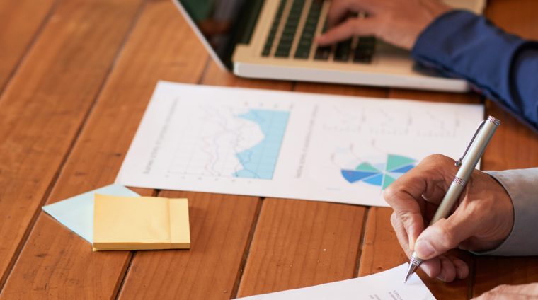Close-up image of entrepreneur checking document before signing
