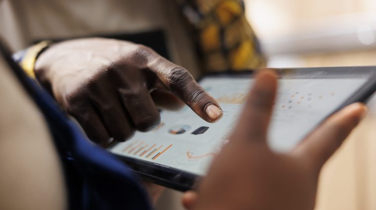 African american warehouse worker hand pointing at inventory statistics on tablet. Storehouse employee asking supervisor about products distribution analytics report and tapping on screen close up